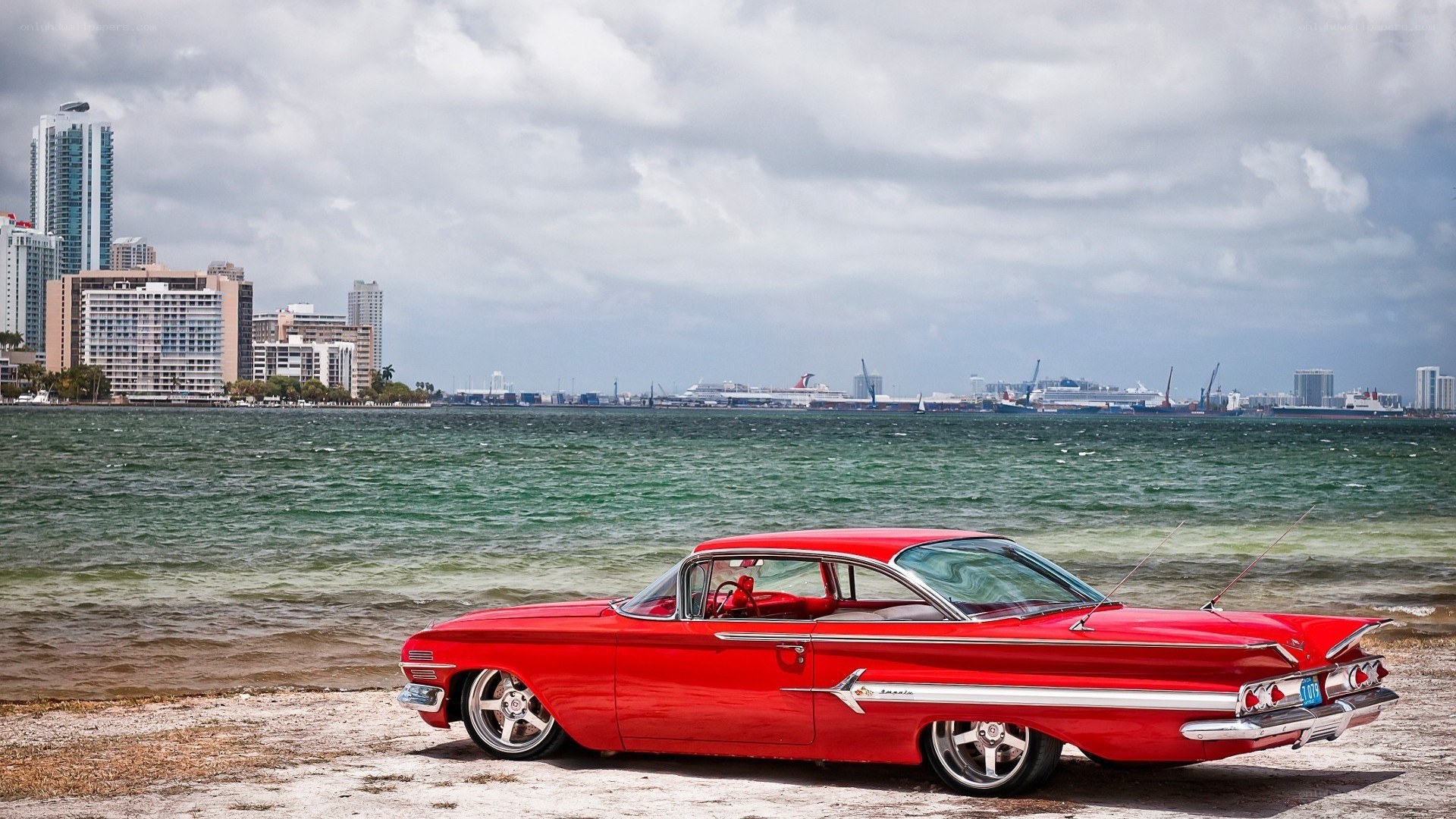 Red classic car on beach