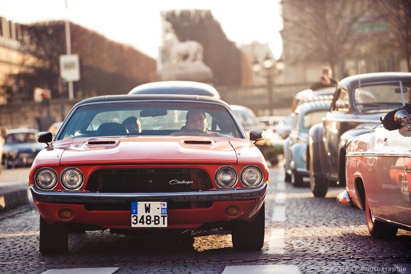Red classic car on cobblestone street