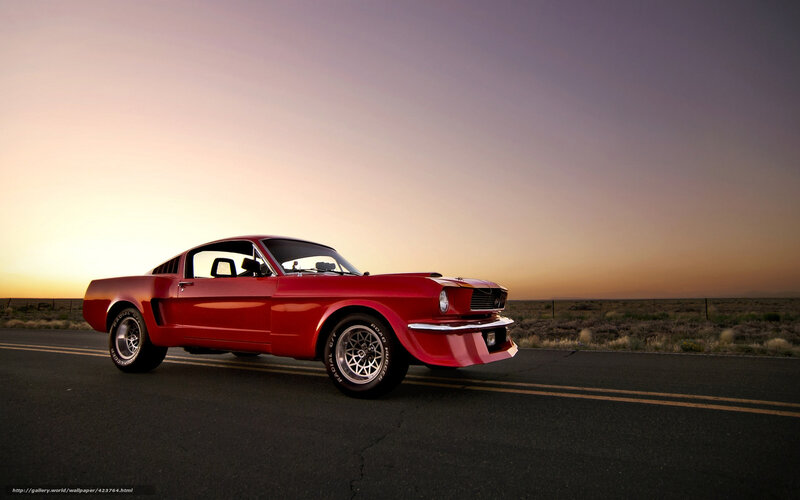 Red classic car on desert road
