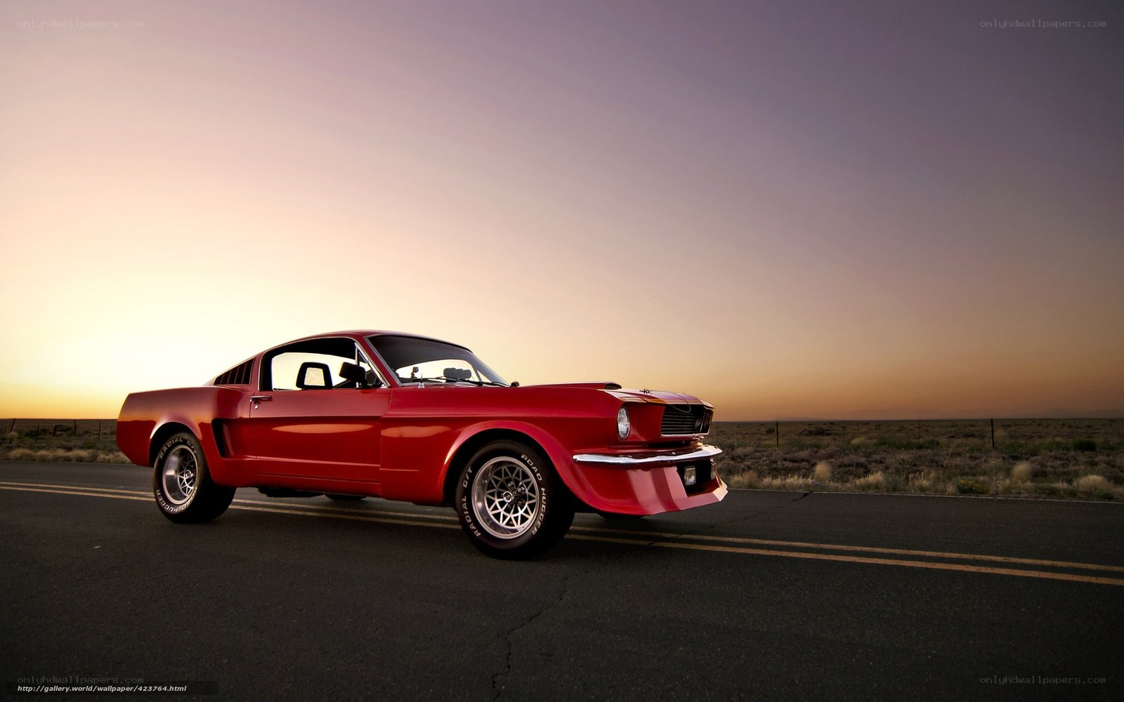 Red classic car on desert road