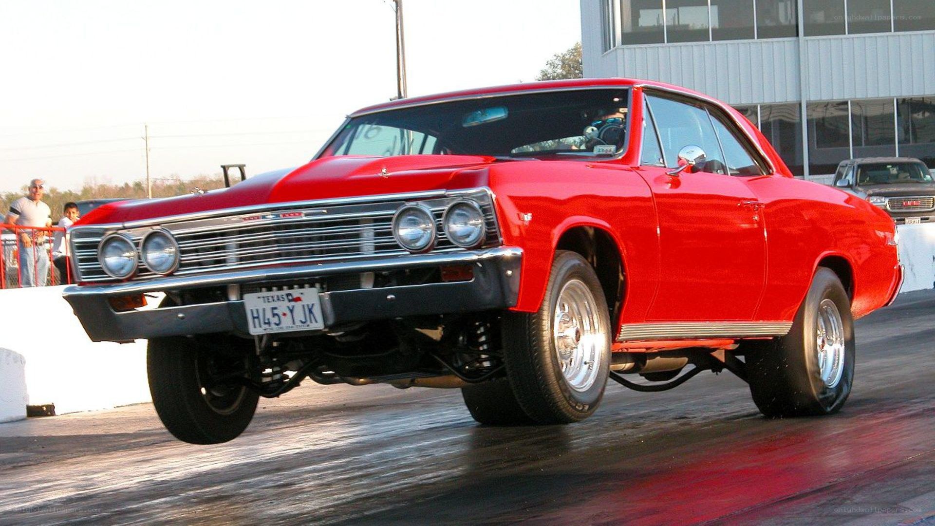 Red classic car on drag strip