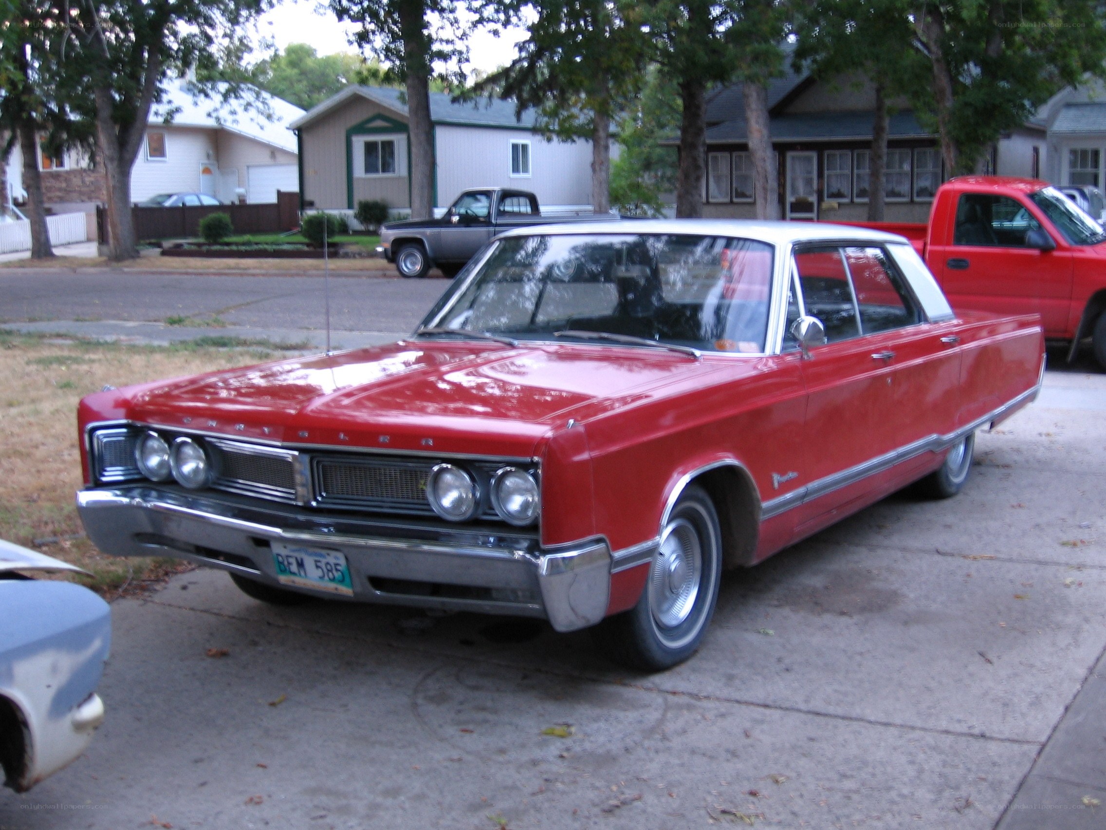 Red classic car on driveway
