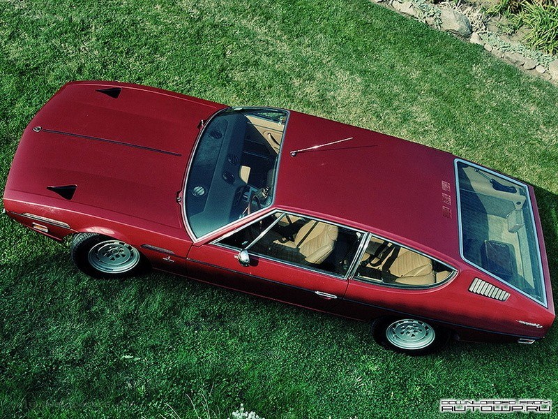 red classic car on grass