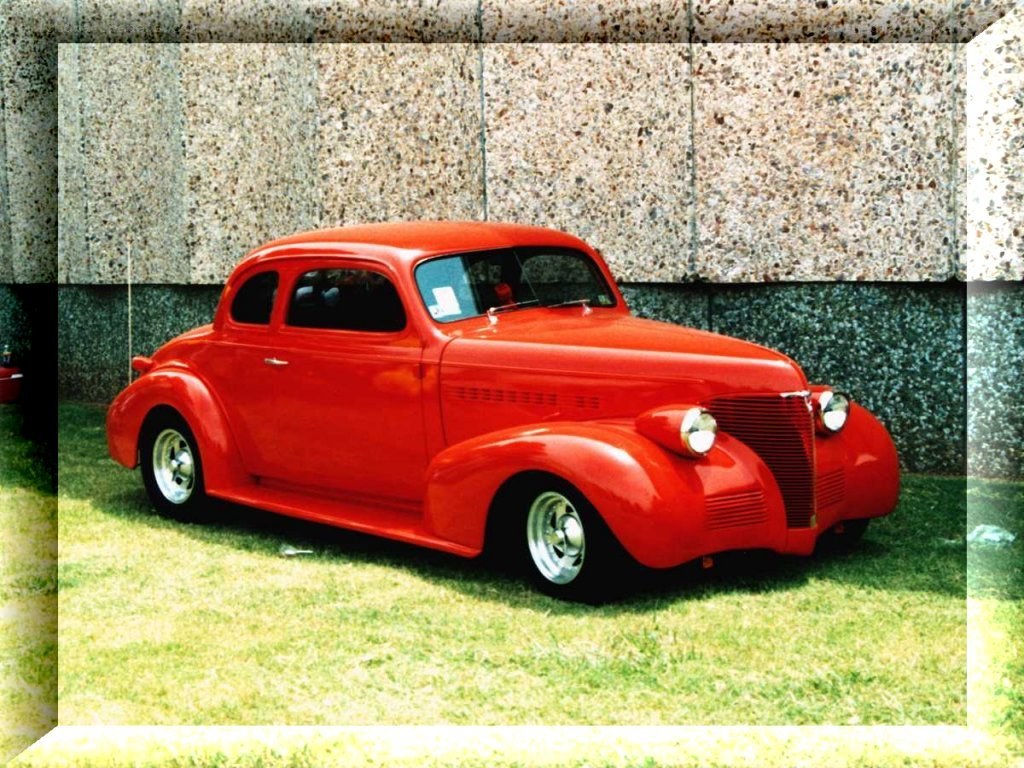 Red classic car on grass