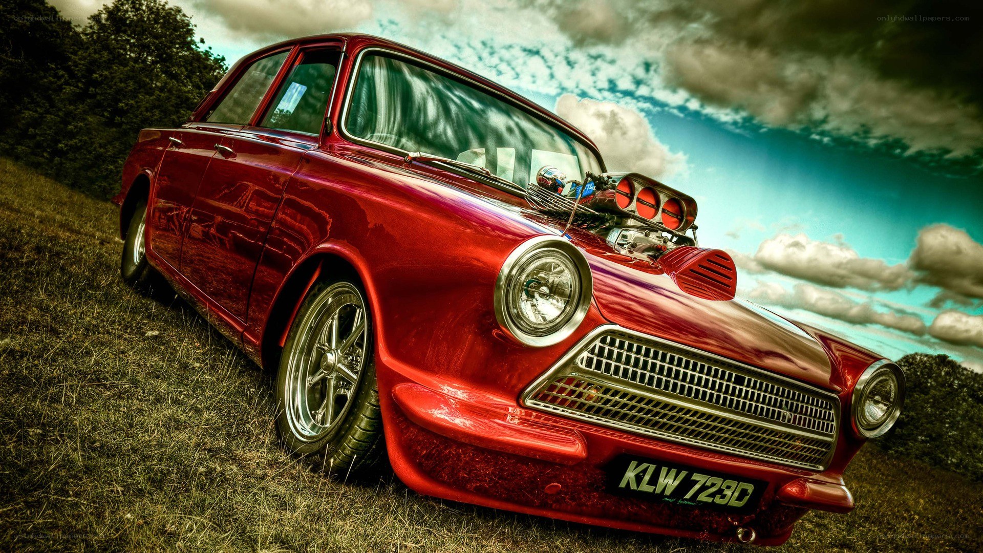 Red classic car on grass
