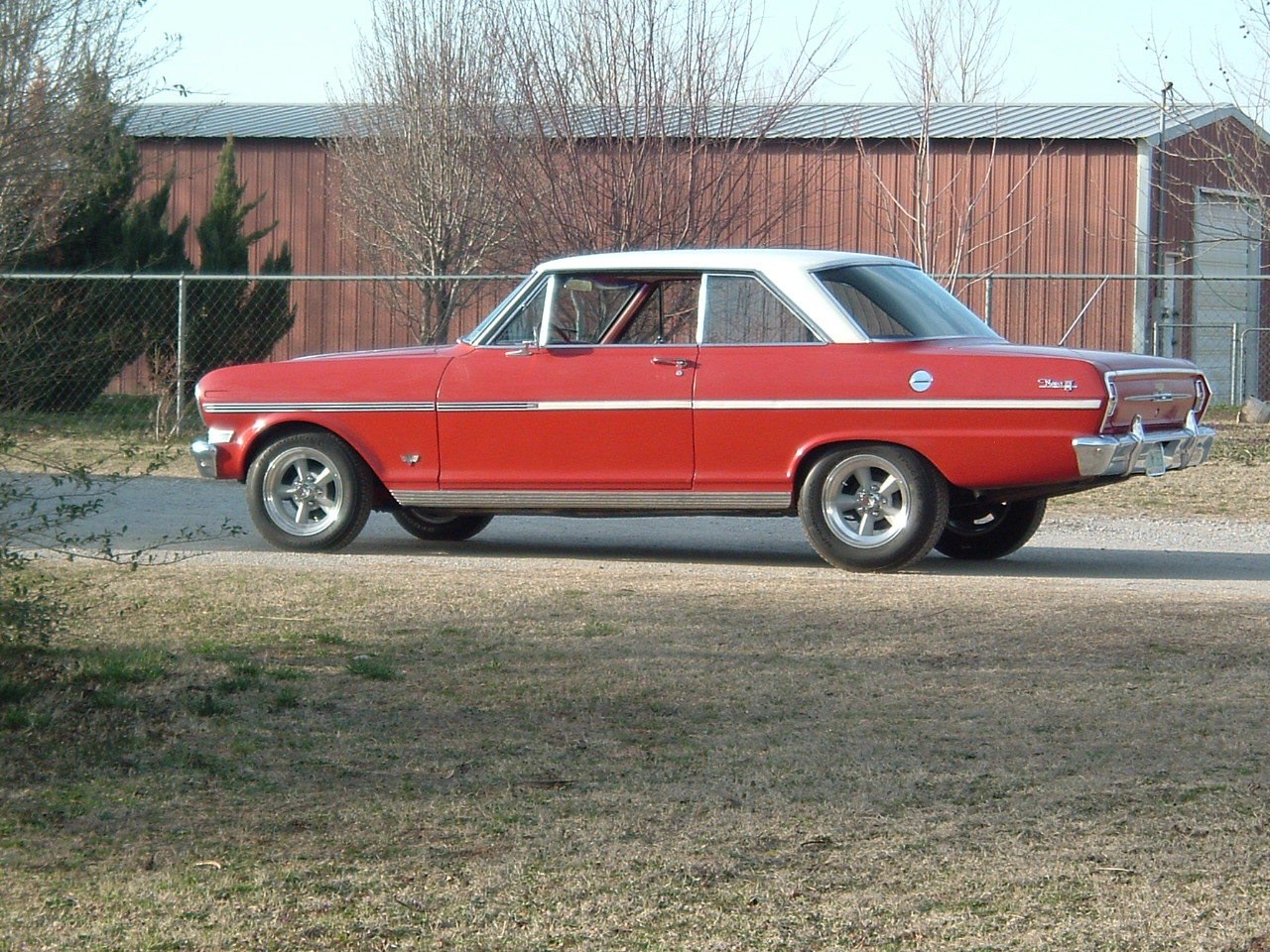Red classic car on gravel