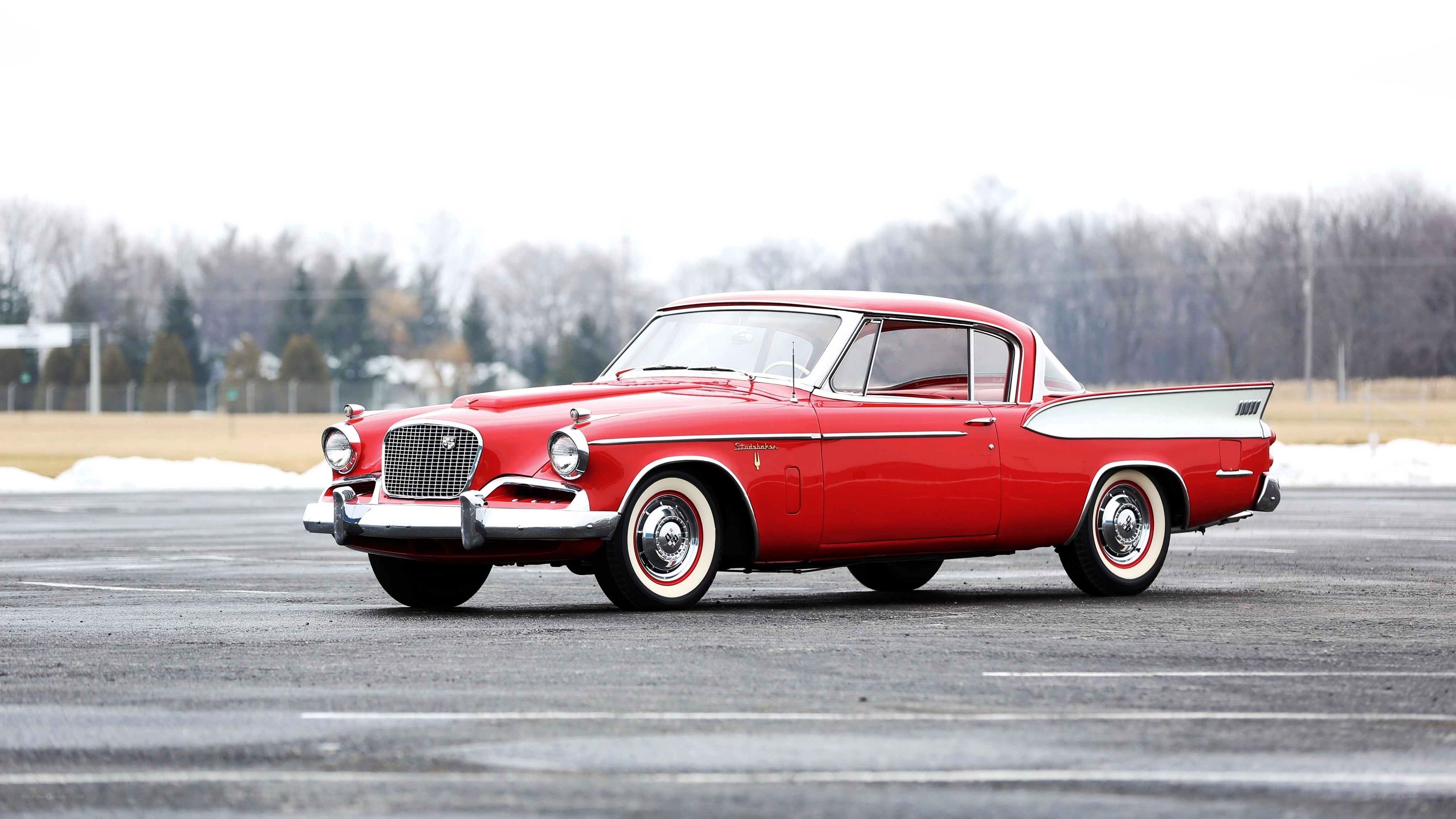 Red classic car on pavement