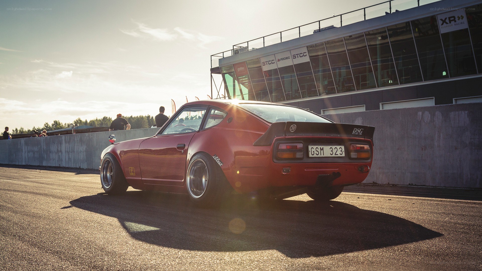 Red classic car on racetrack