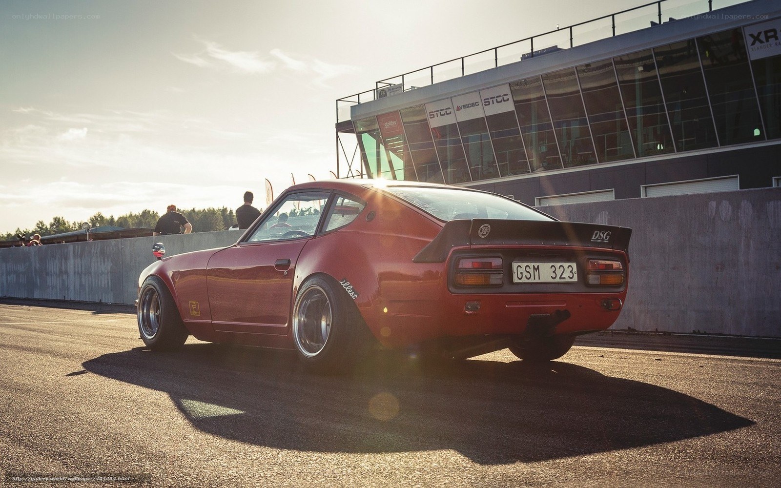 Red classic car on racetrack