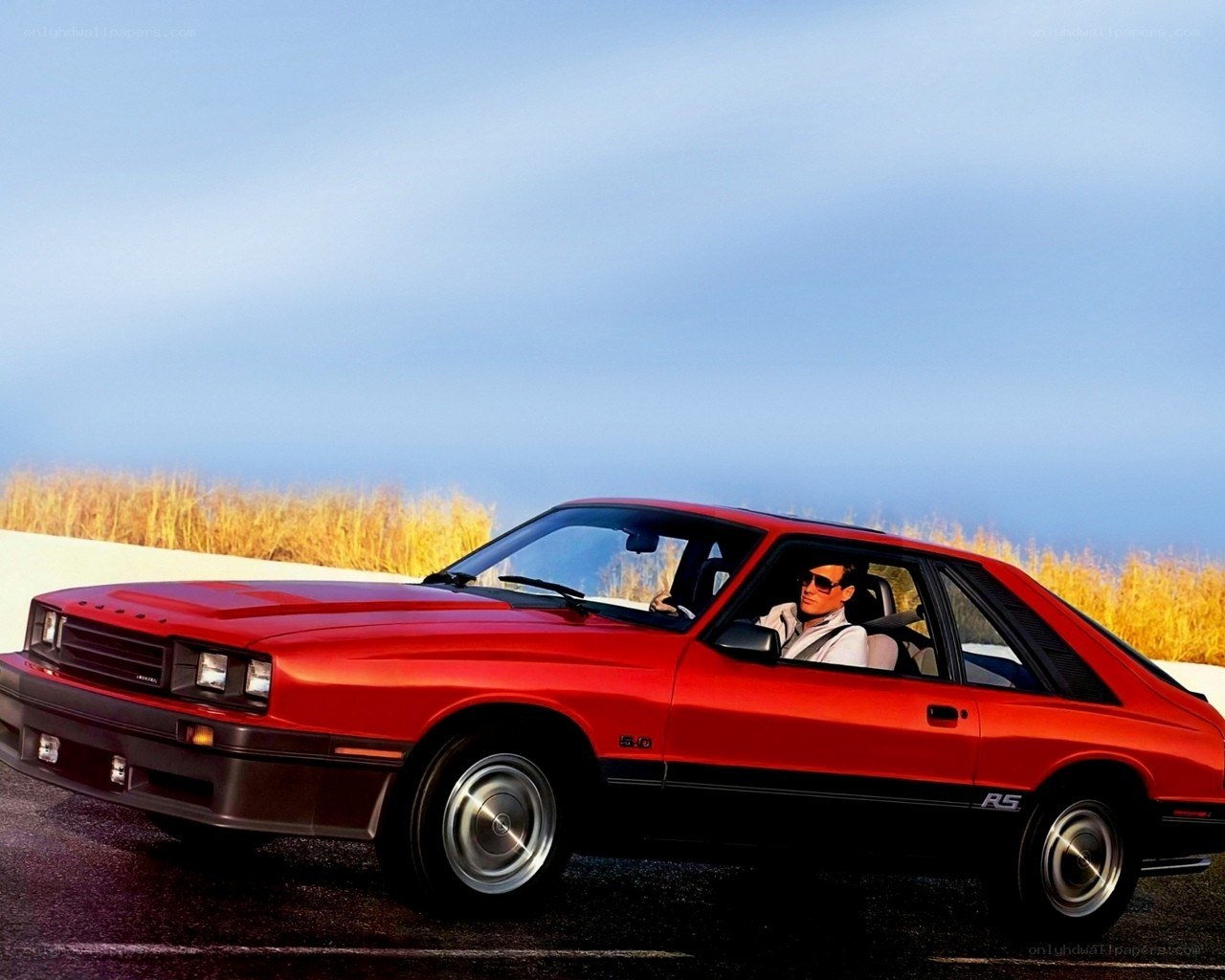 Red classic car on road