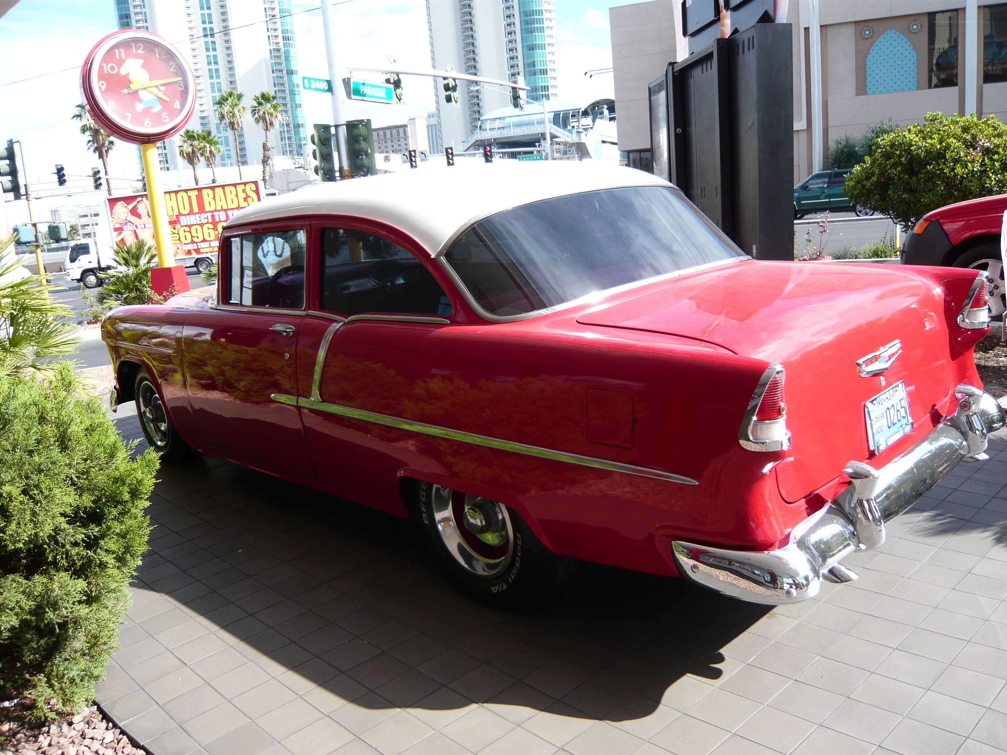 Red classic car on sidewalk