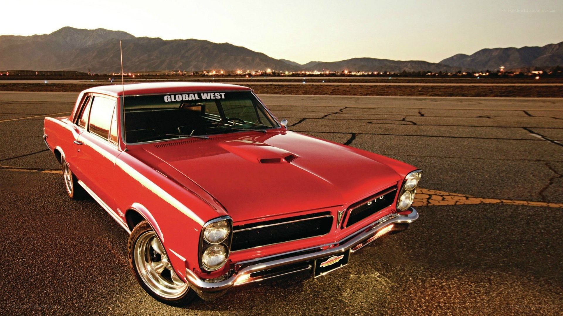 Red classic car on tarmac