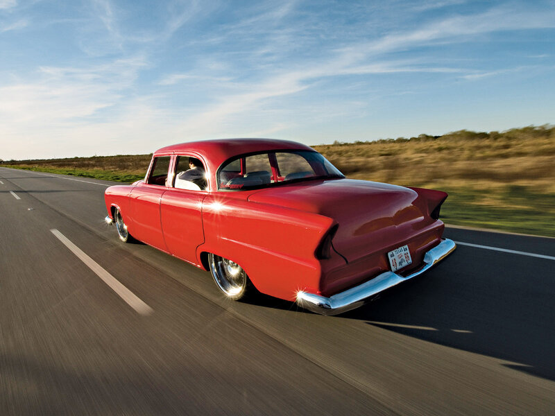 Red classic car on the road