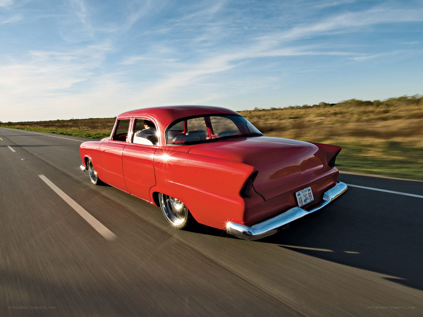 Red classic car on the road