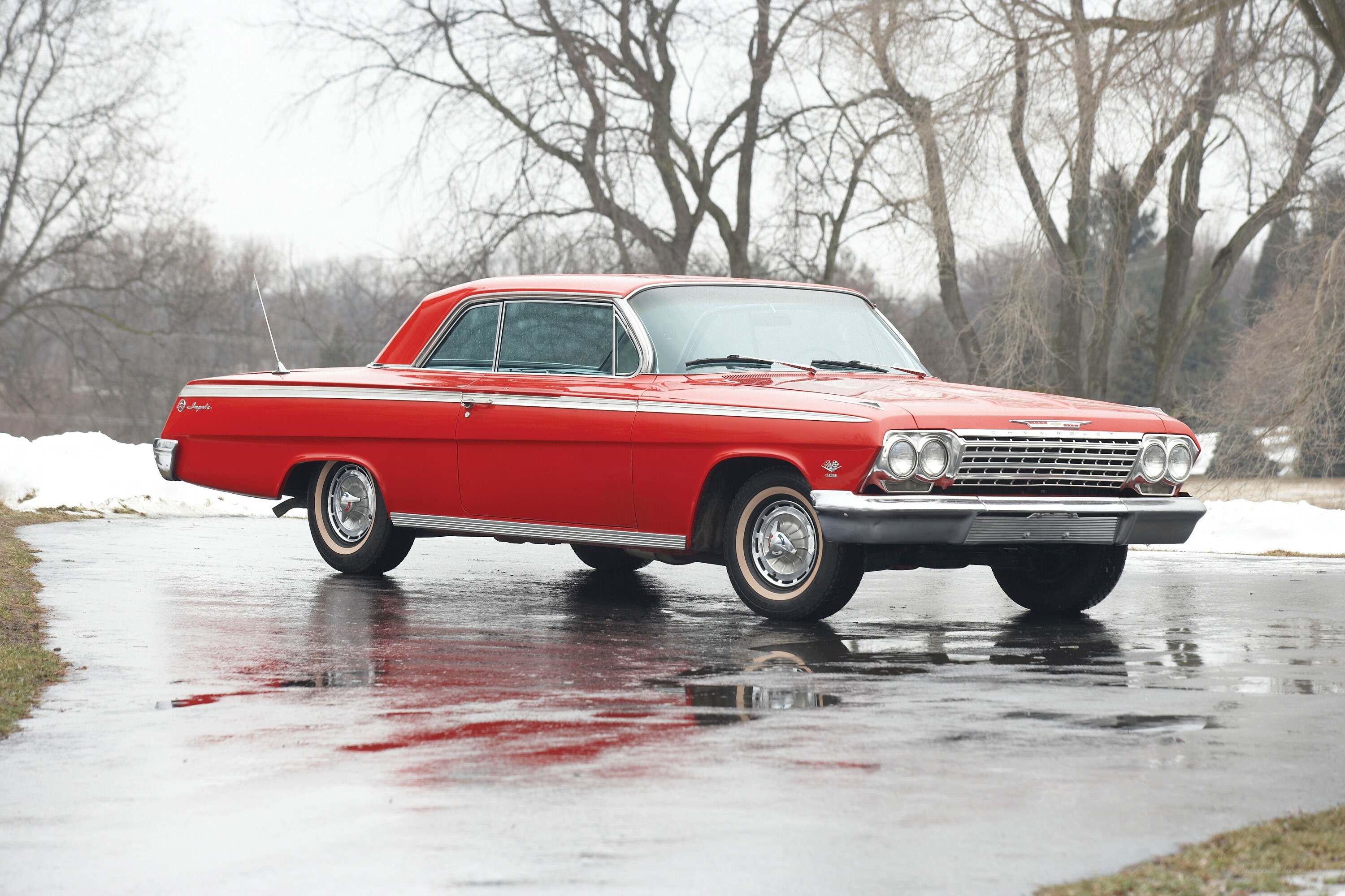 Red classic car on wet pavement