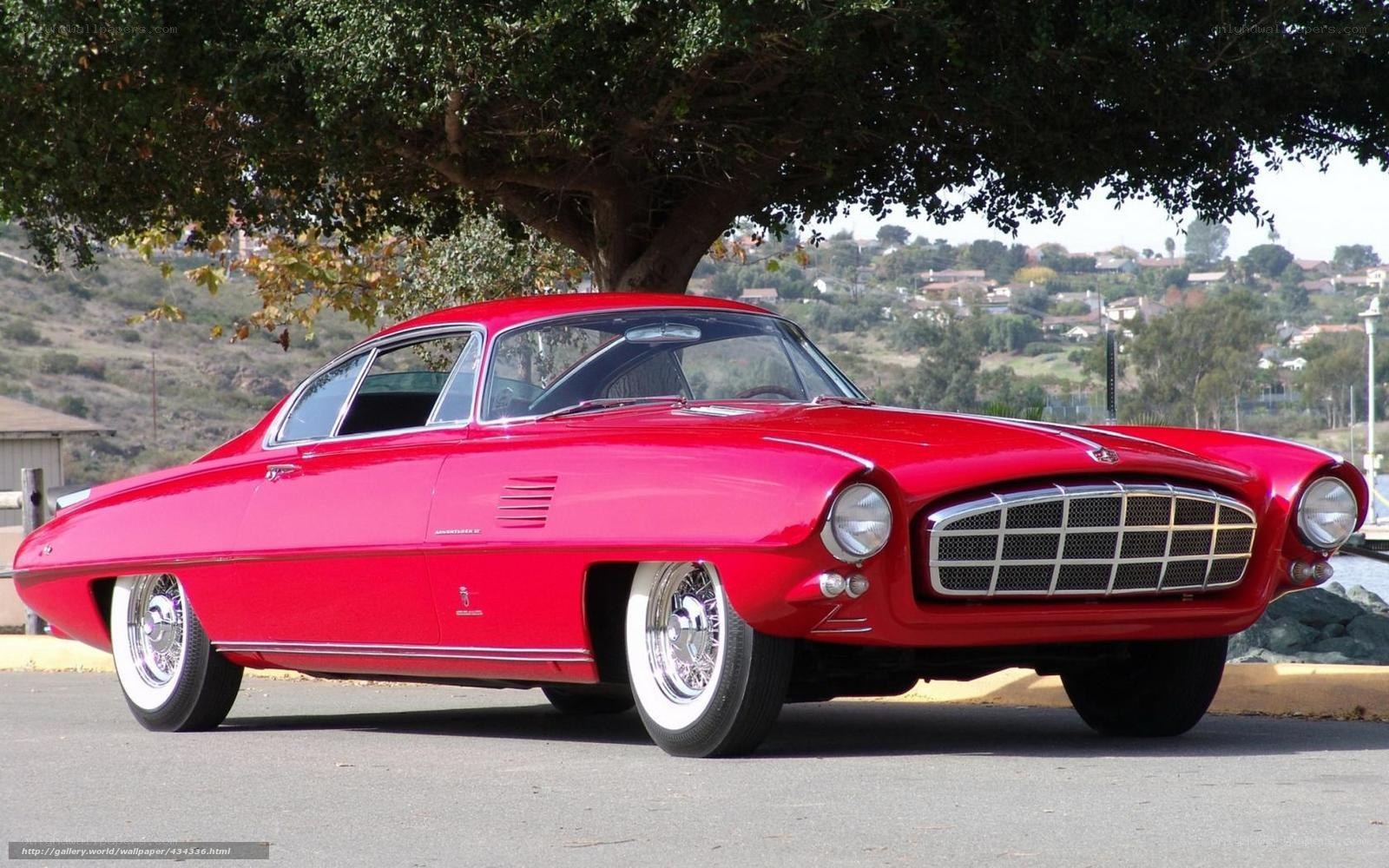 Red classic car under tree