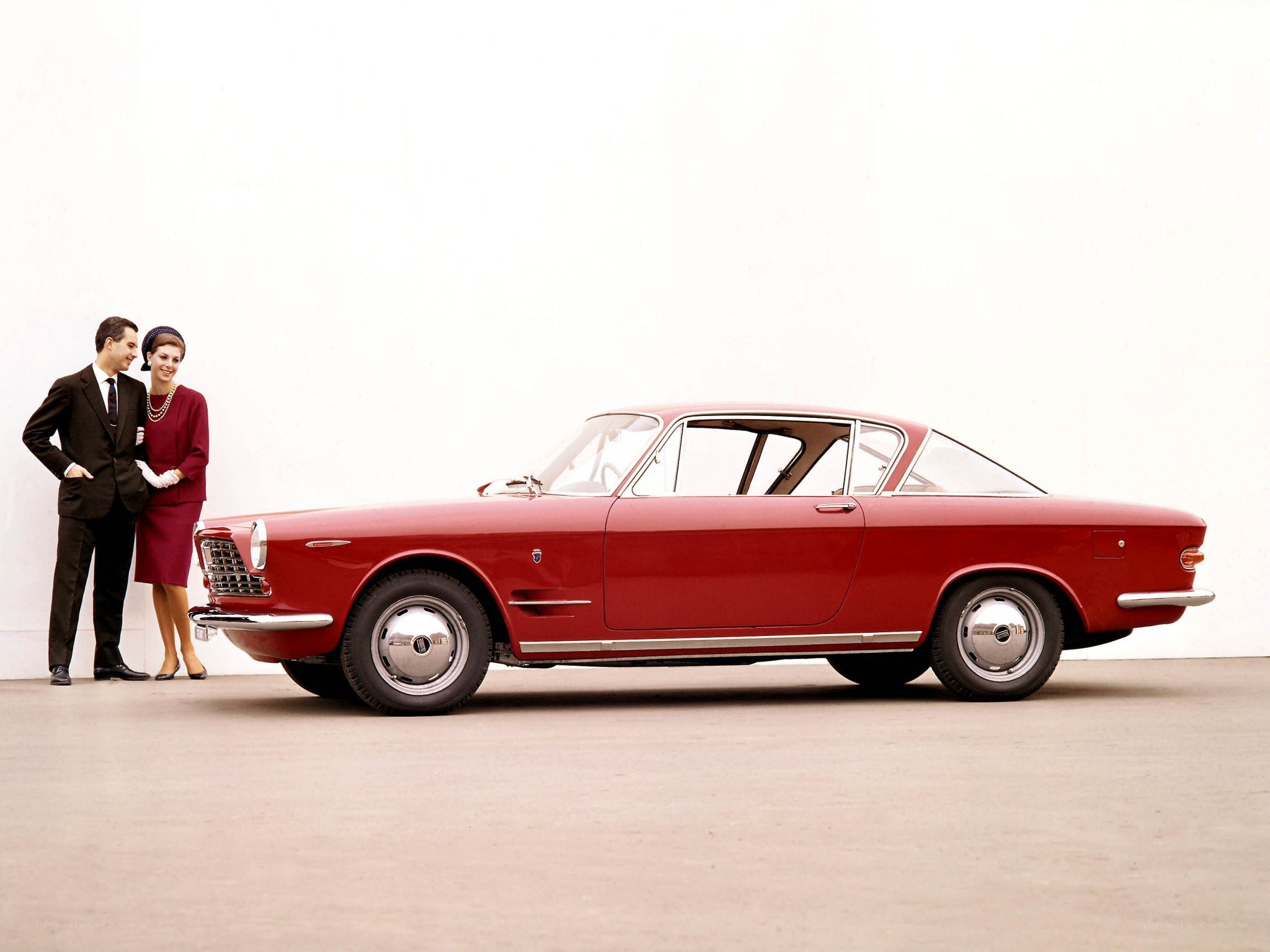 Red classic car with couple