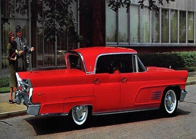 Red classic car with couple
