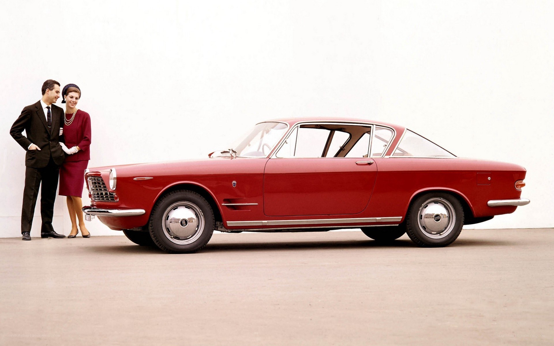 Red classic car with couple