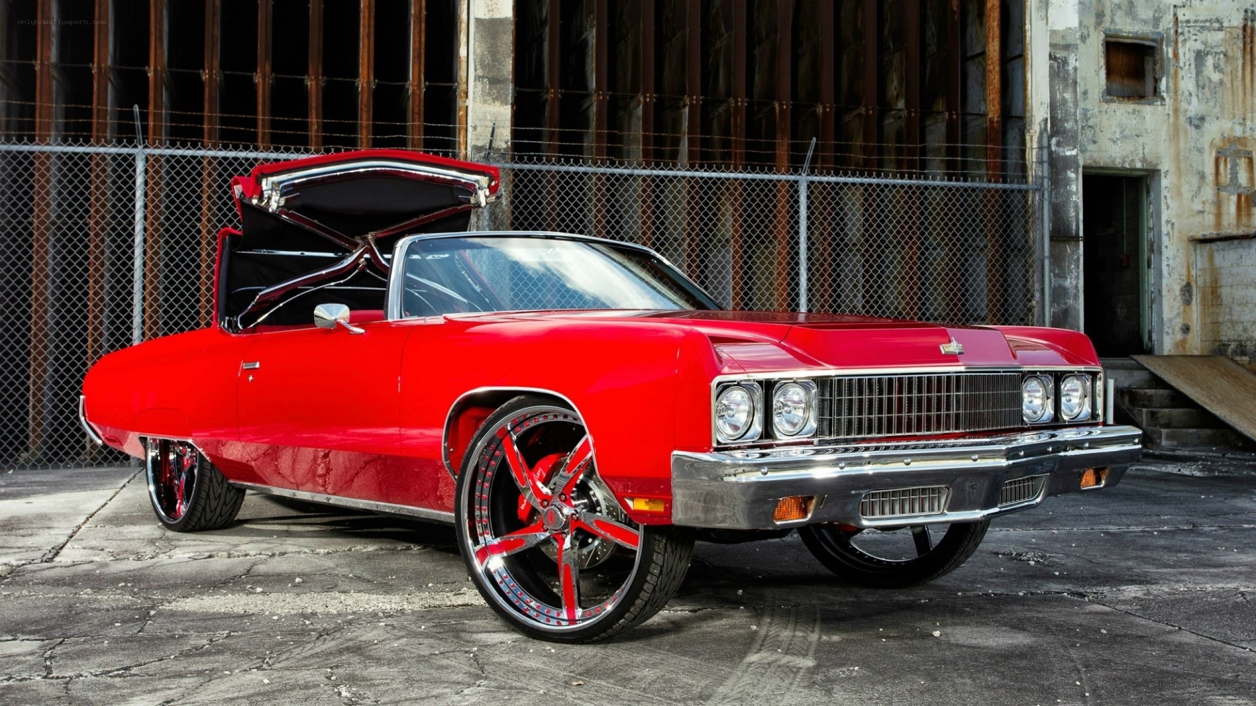 Red classic car with custom wheels