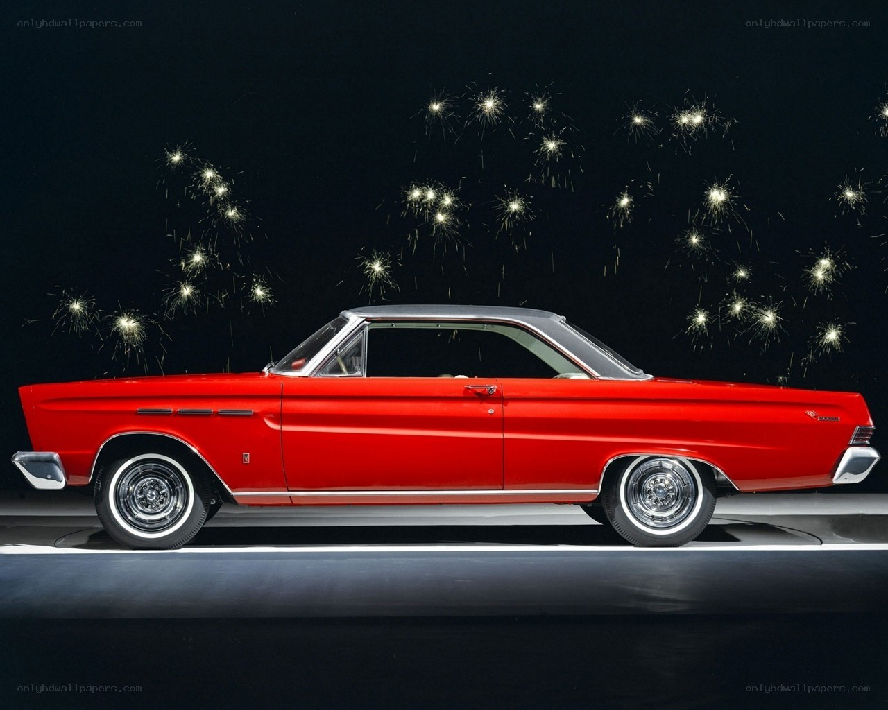 Red classic car with fireworks