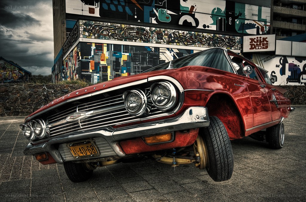 Red classic car with graffiti background