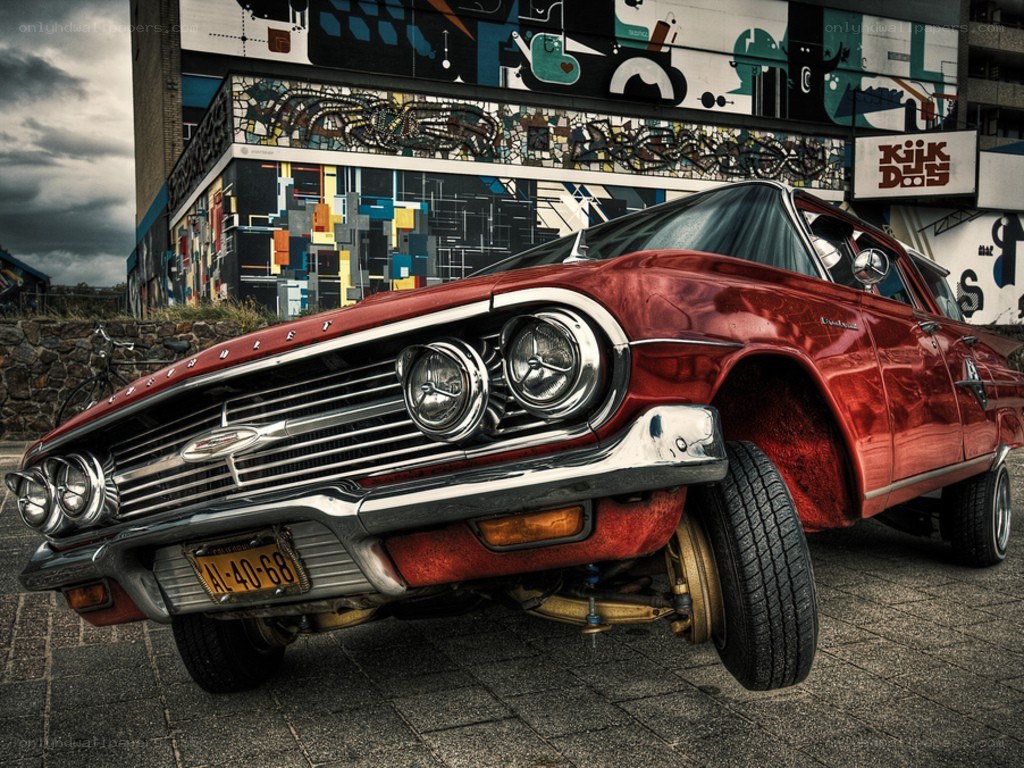 Red classic car with graffiti background