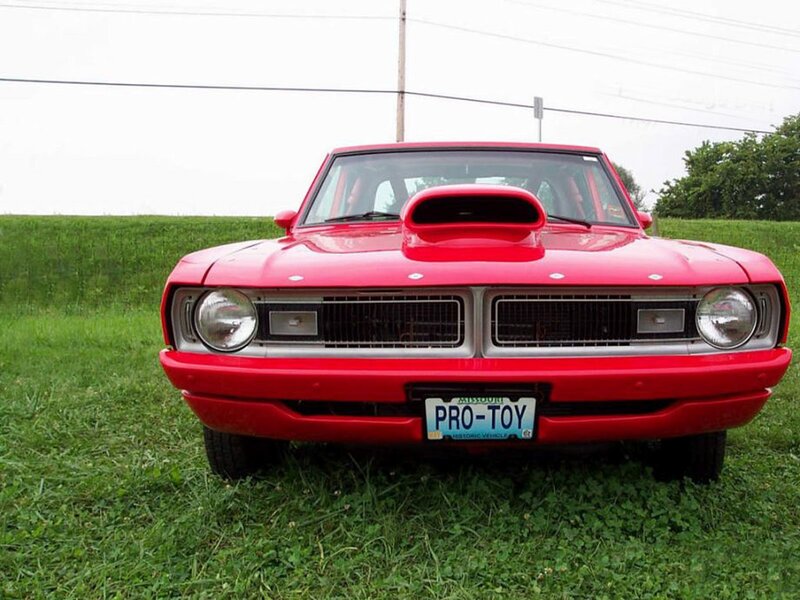 Red classic car with hood scoop