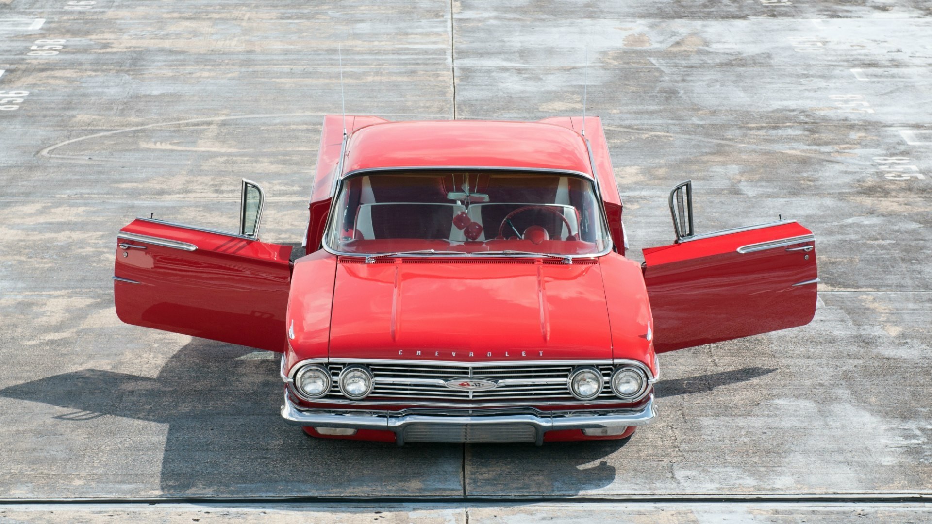 Red classic car with open doors