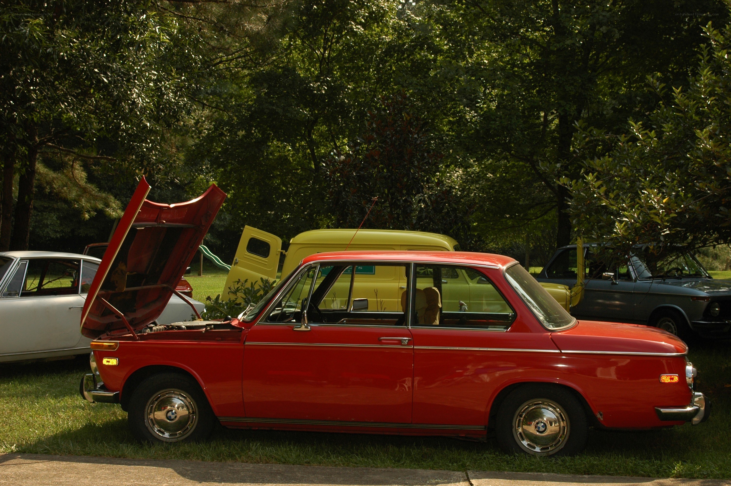 Red classic car with open hood