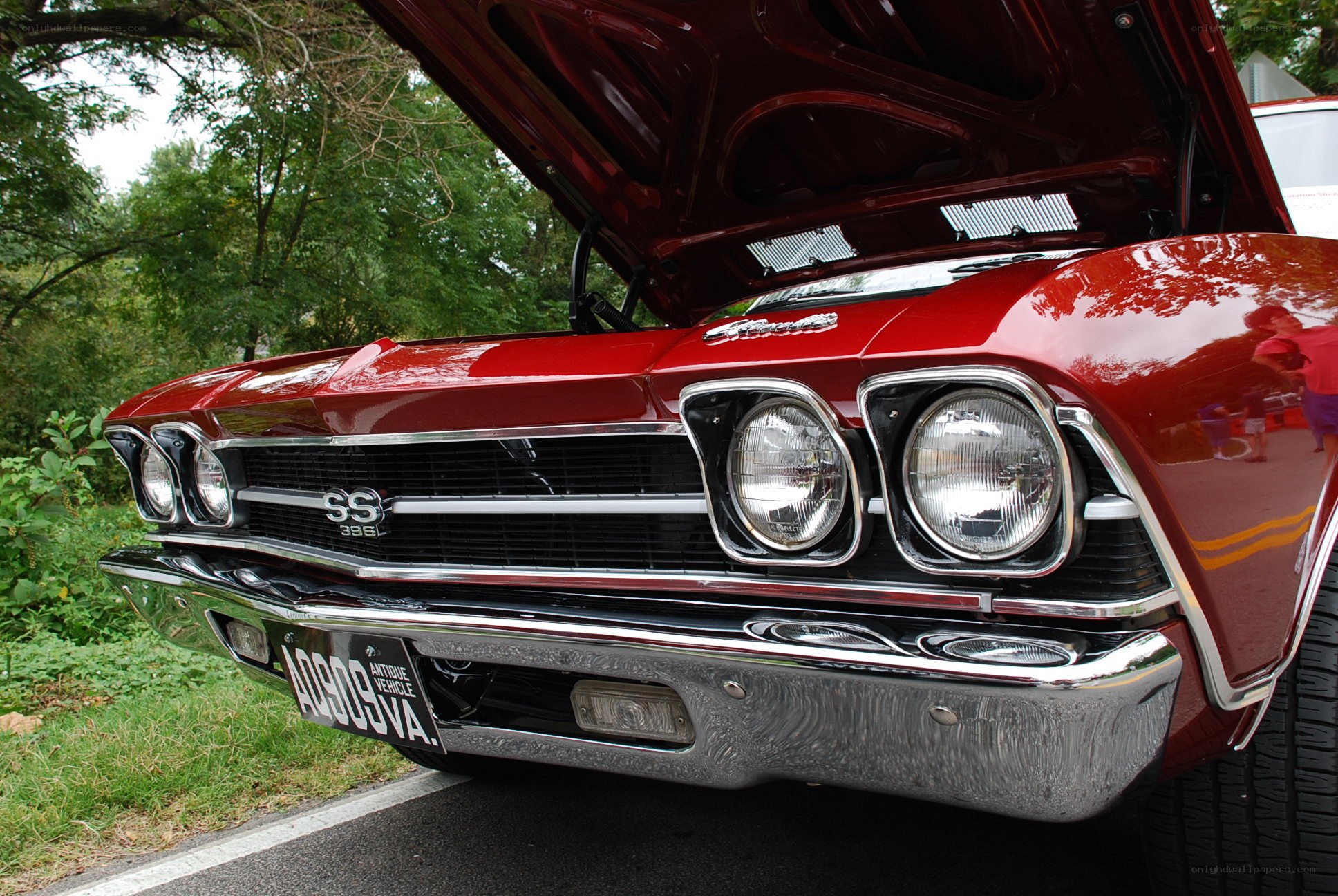 Red classic car with open hood