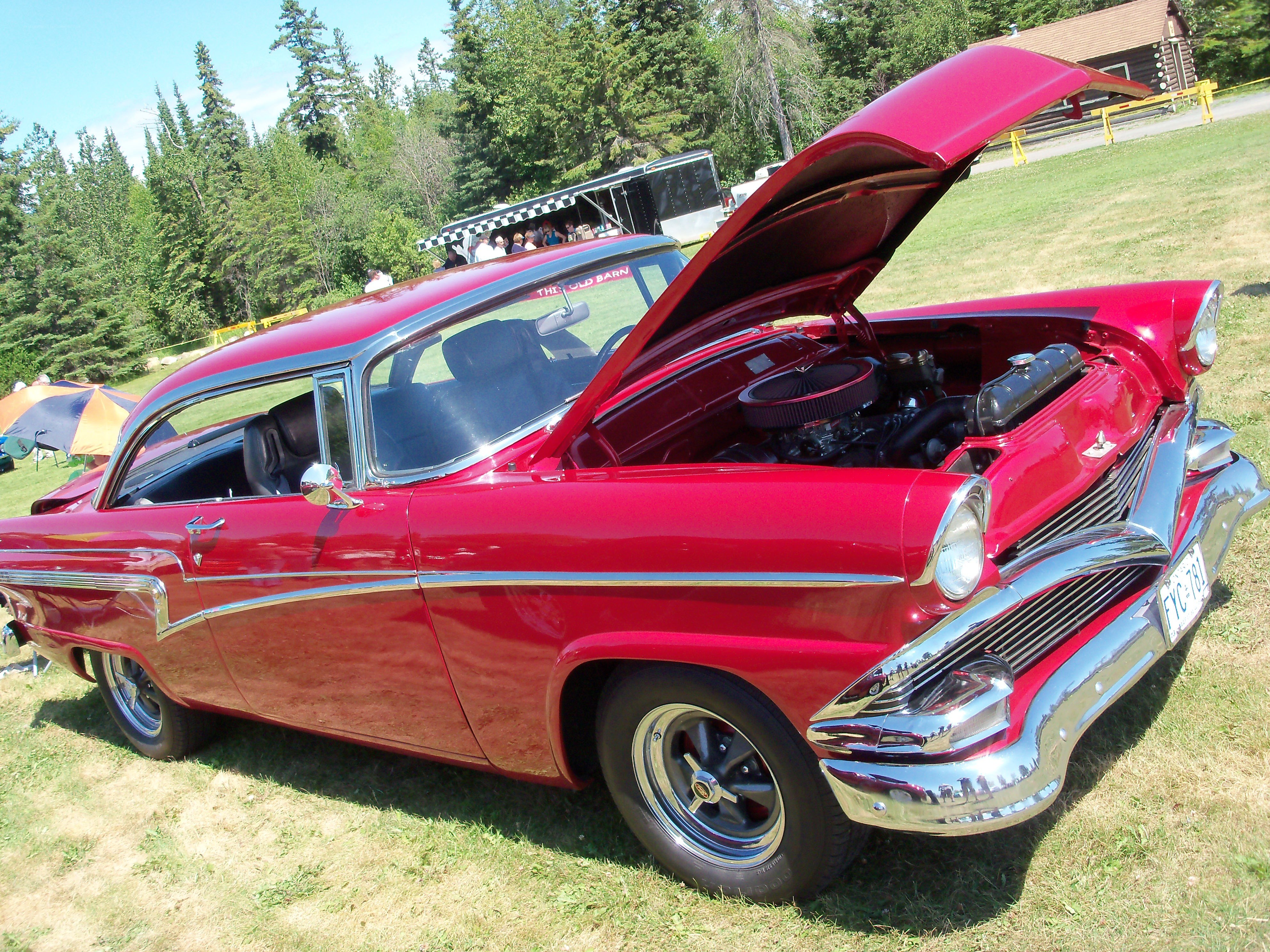 Red classic car with open hood