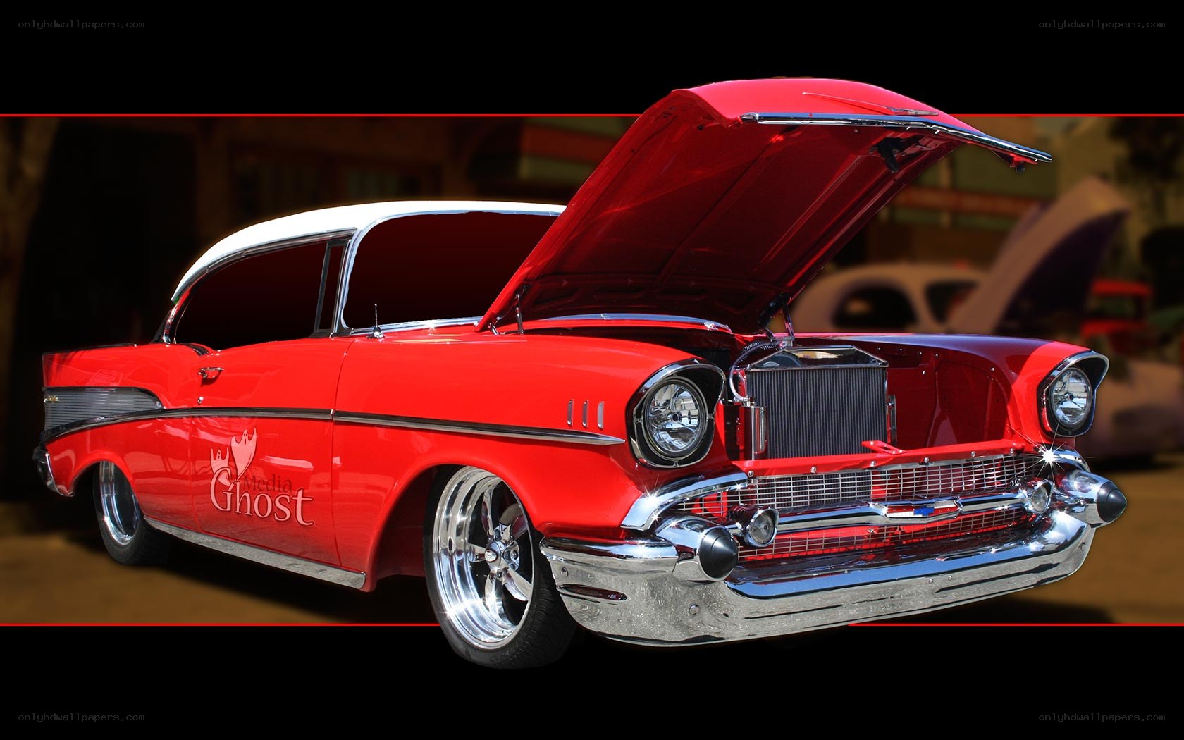Red classic car with open hood