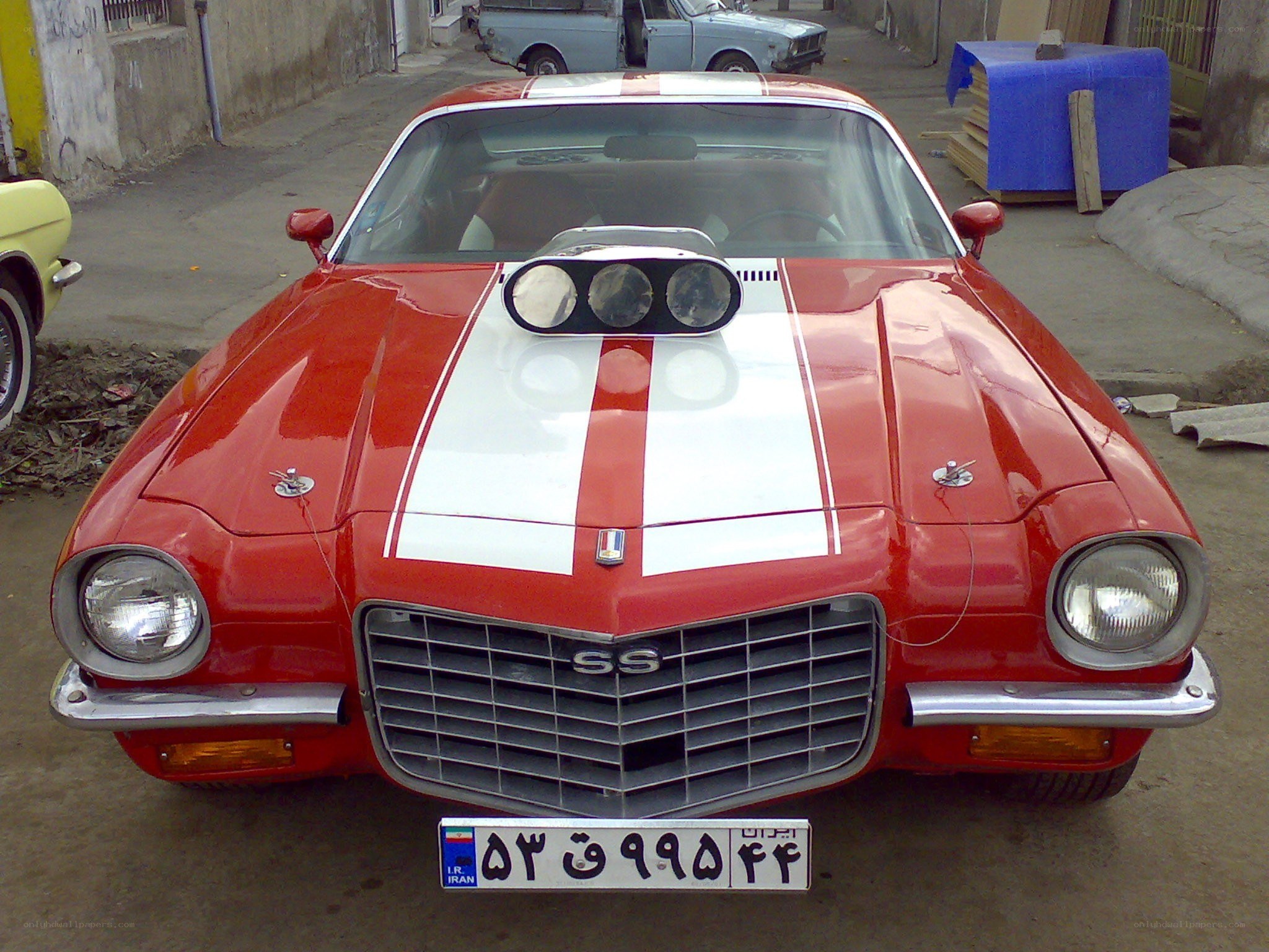 Red classic car with racing stripes