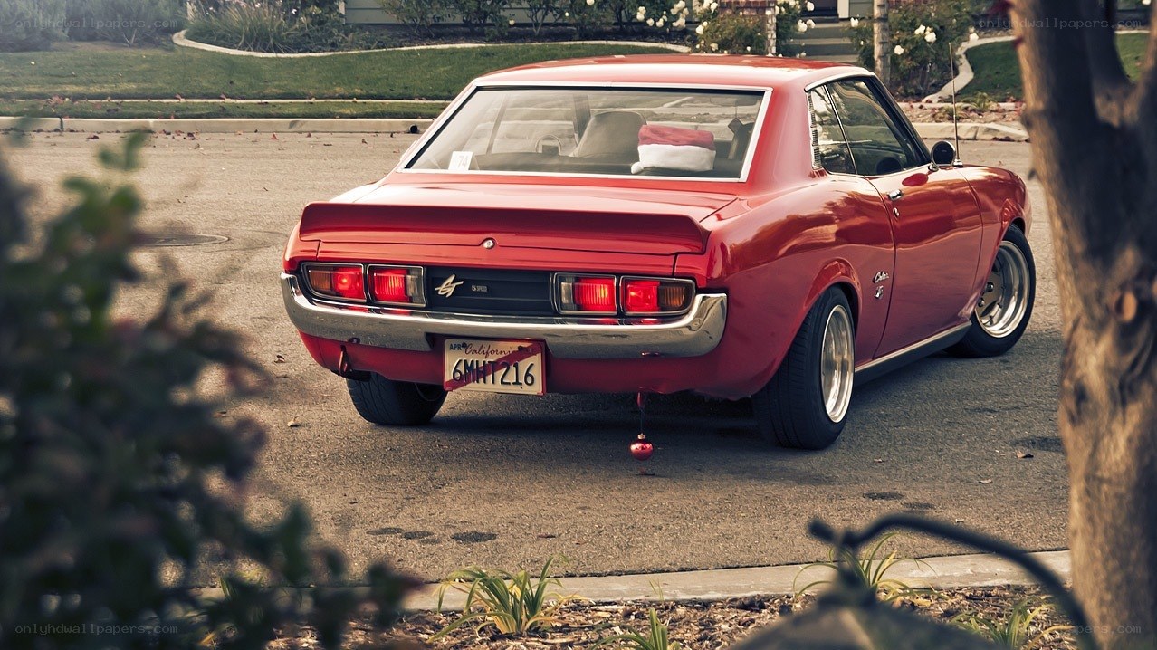 Red classic car with Santa hat