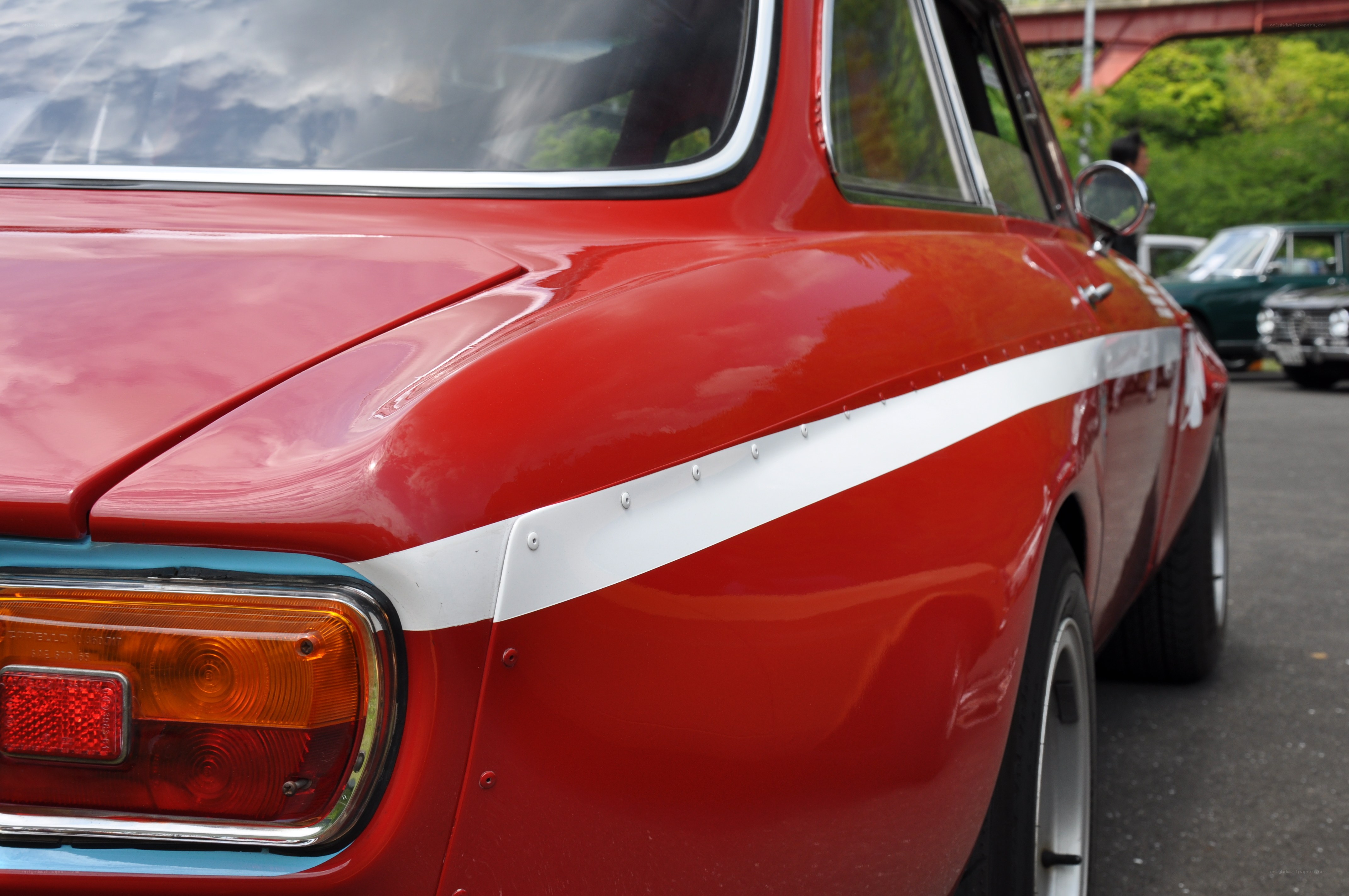 Red classic car with white stripe