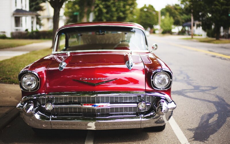 Red classic Chevrolet parked on street