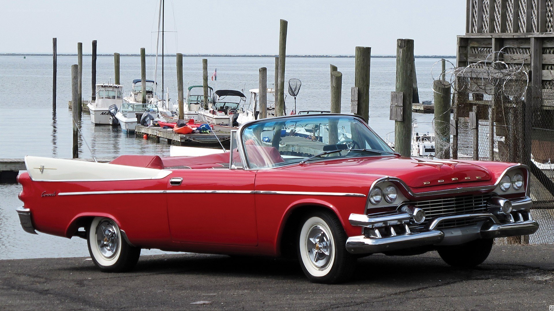 Red classic convertible at marina