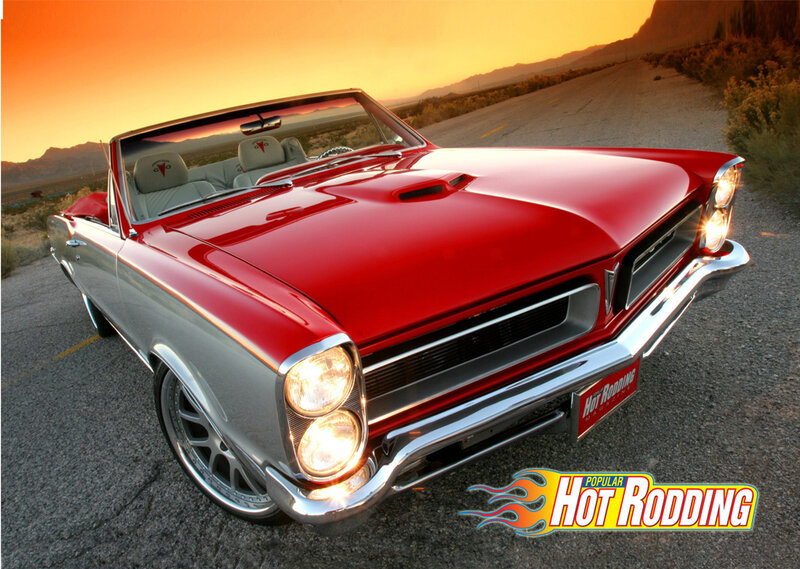 Red classic convertible at sunset