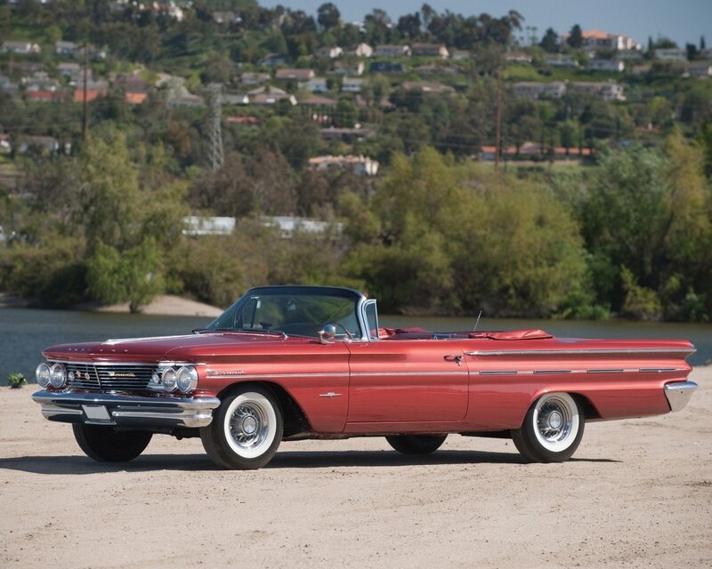 Red classic convertible by the water