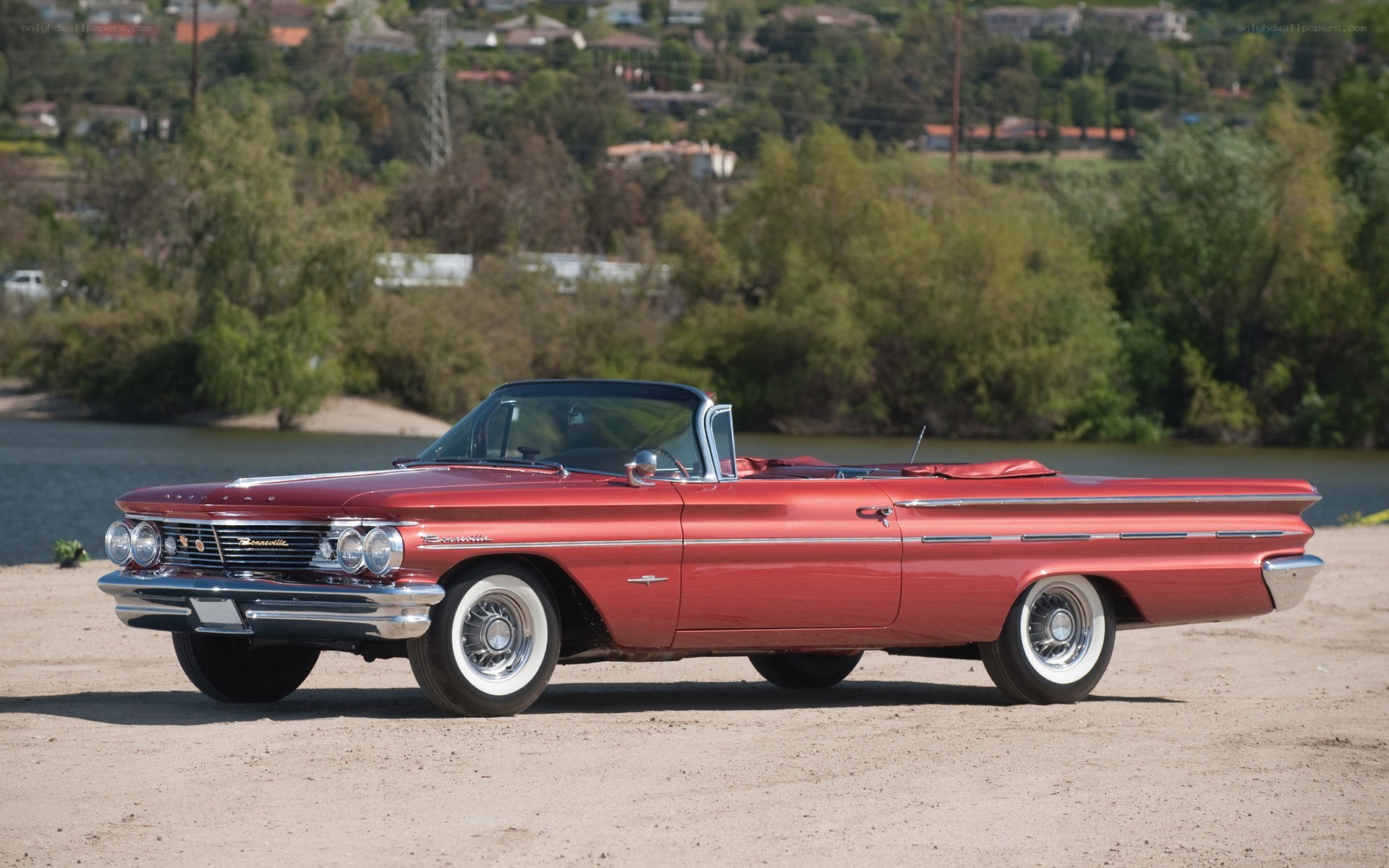Red classic convertible by water