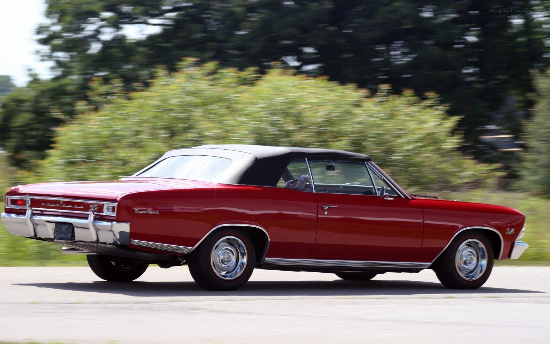 Red classic convertible in motion