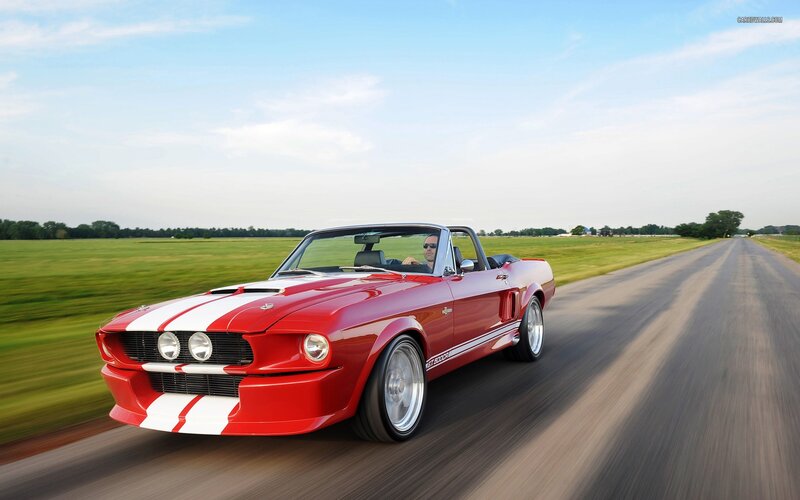 Red classic convertible on country road