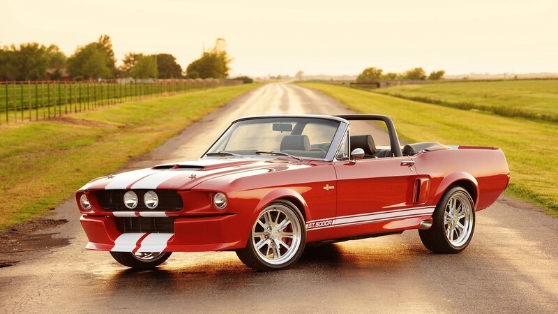 Red classic convertible on country road
