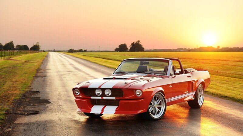 Red classic convertible on country road