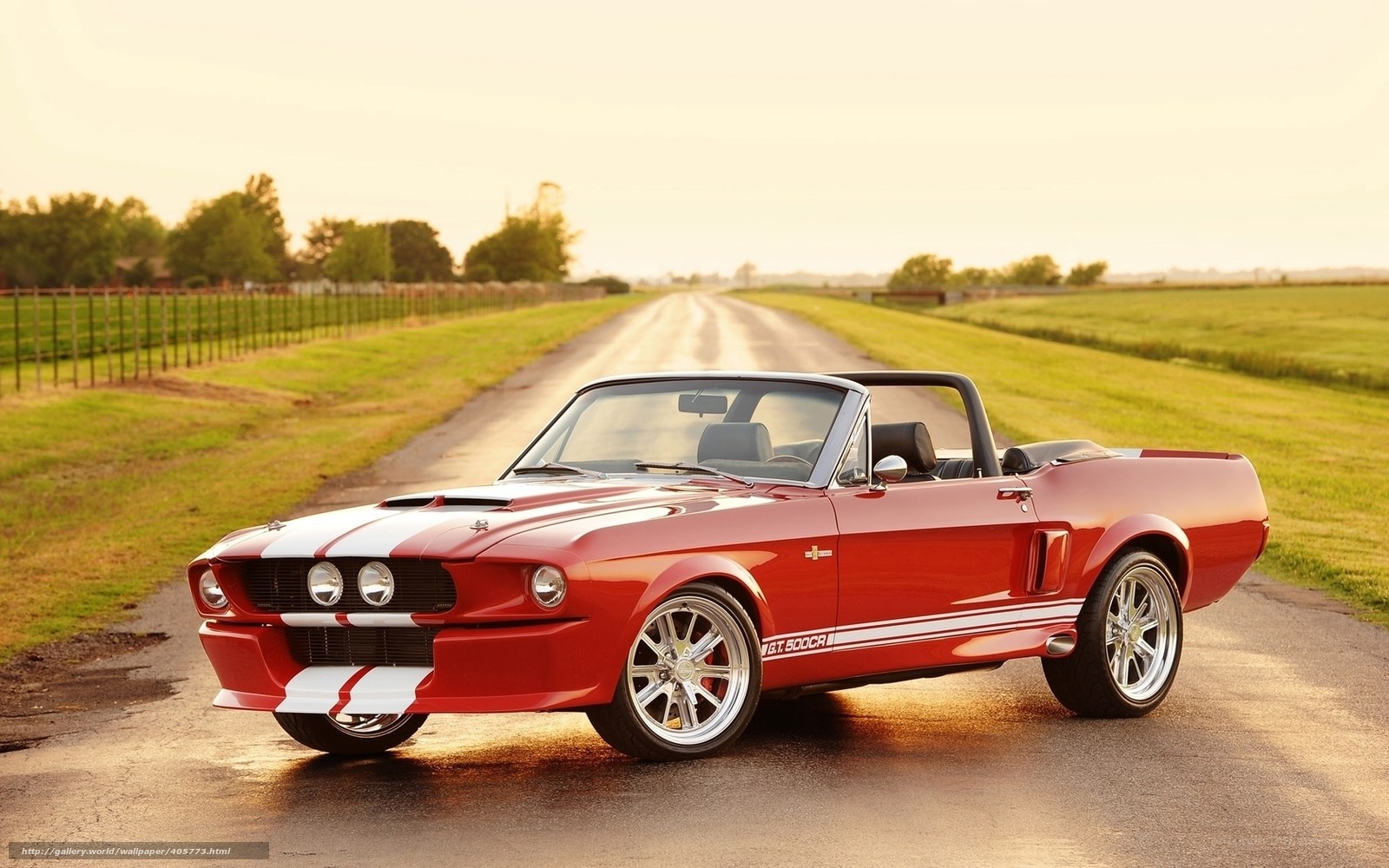 Red classic convertible on country road