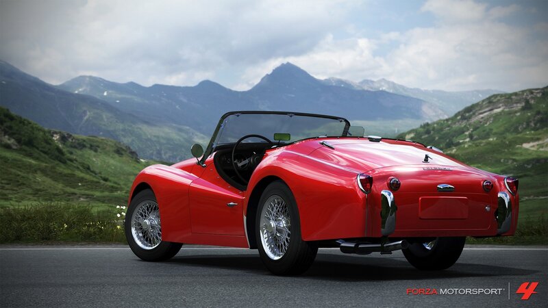 Red classic convertible on mountain road