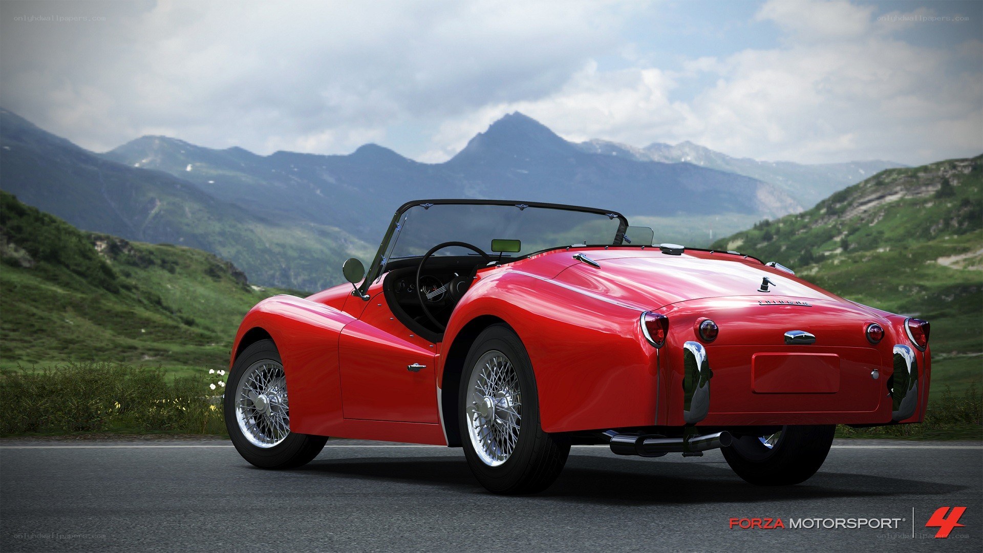 Red classic convertible on mountain road