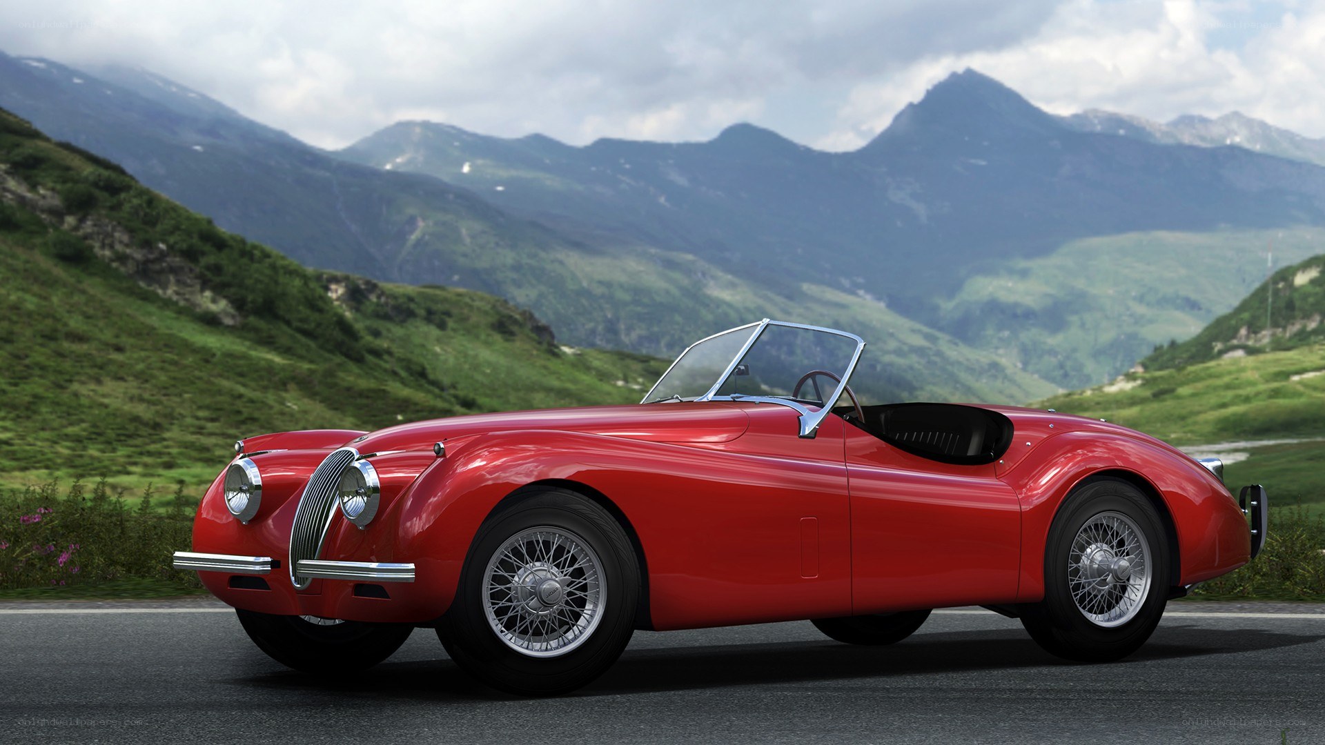 Red classic convertible on mountain road