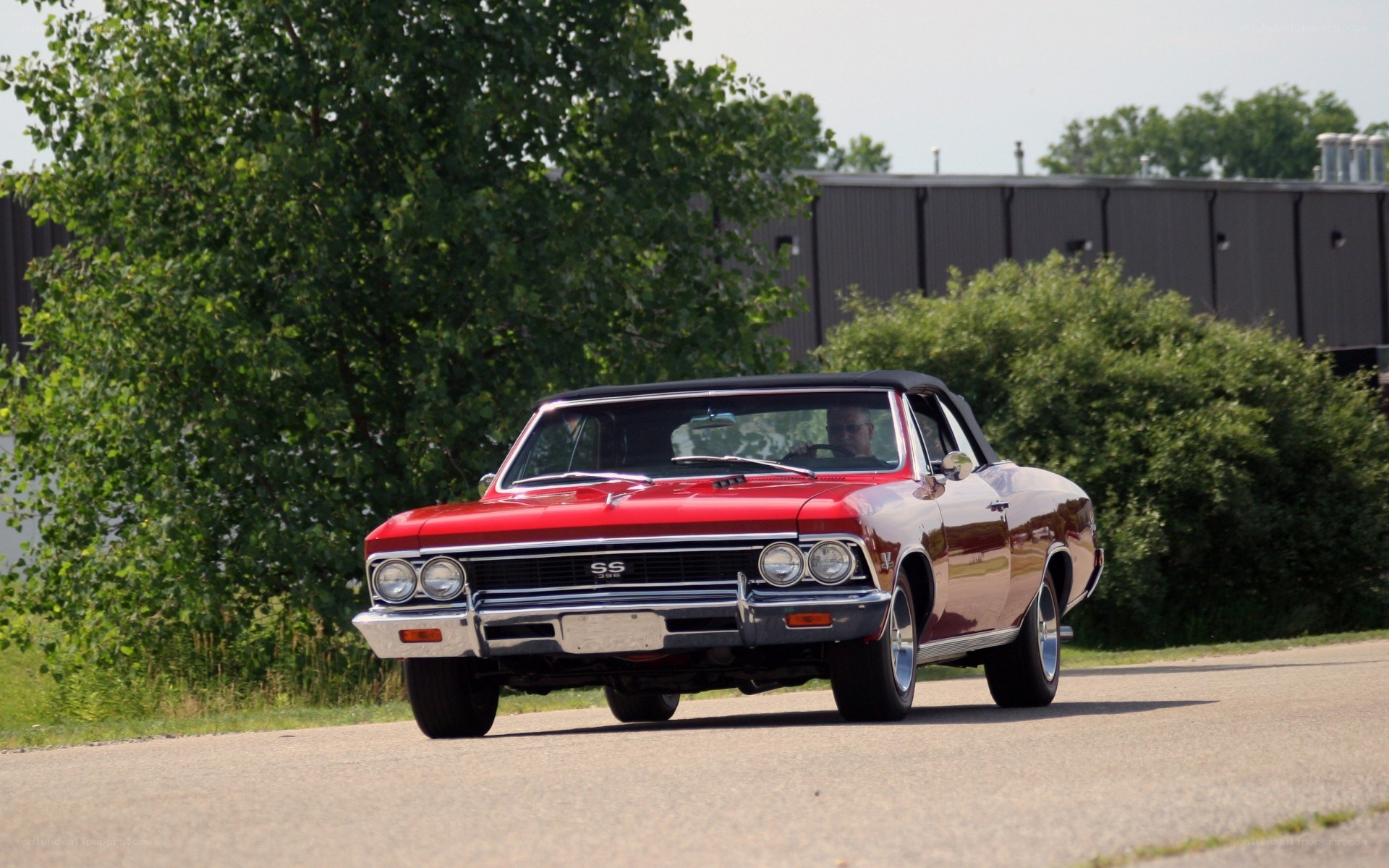 Red classic convertible on road